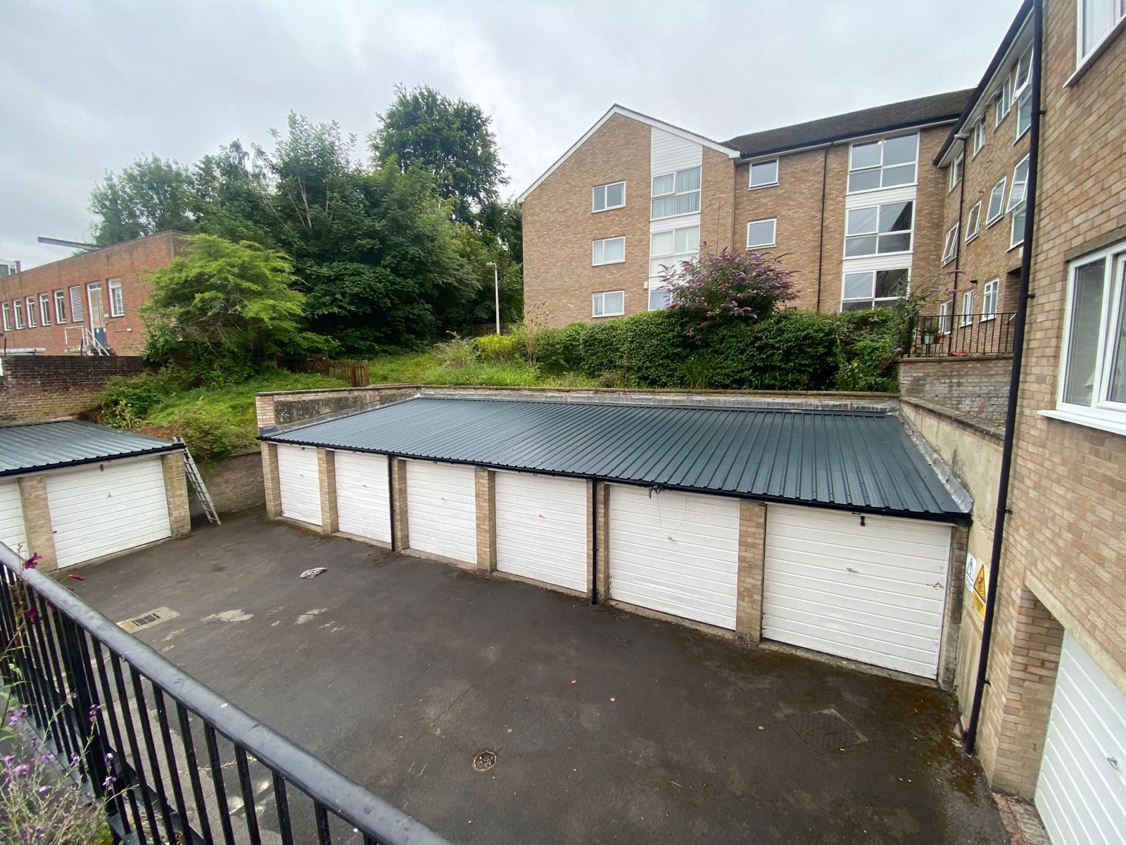Communal garage block with new steel box-profile roof — after