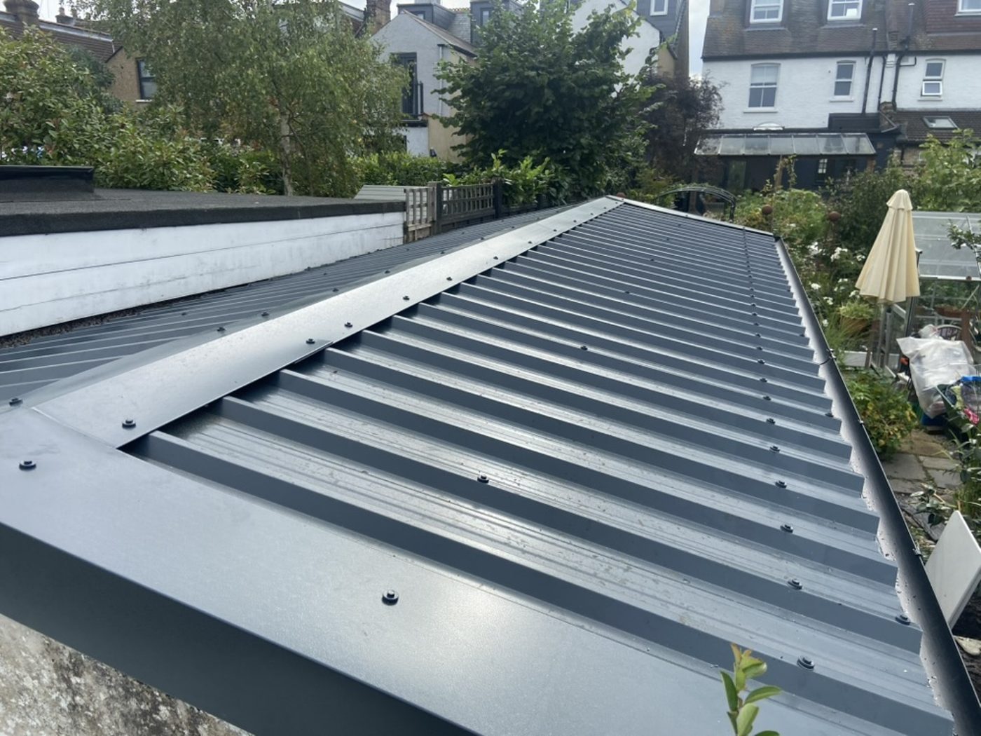 Same garage with asbestos removed and a new steel roof — after