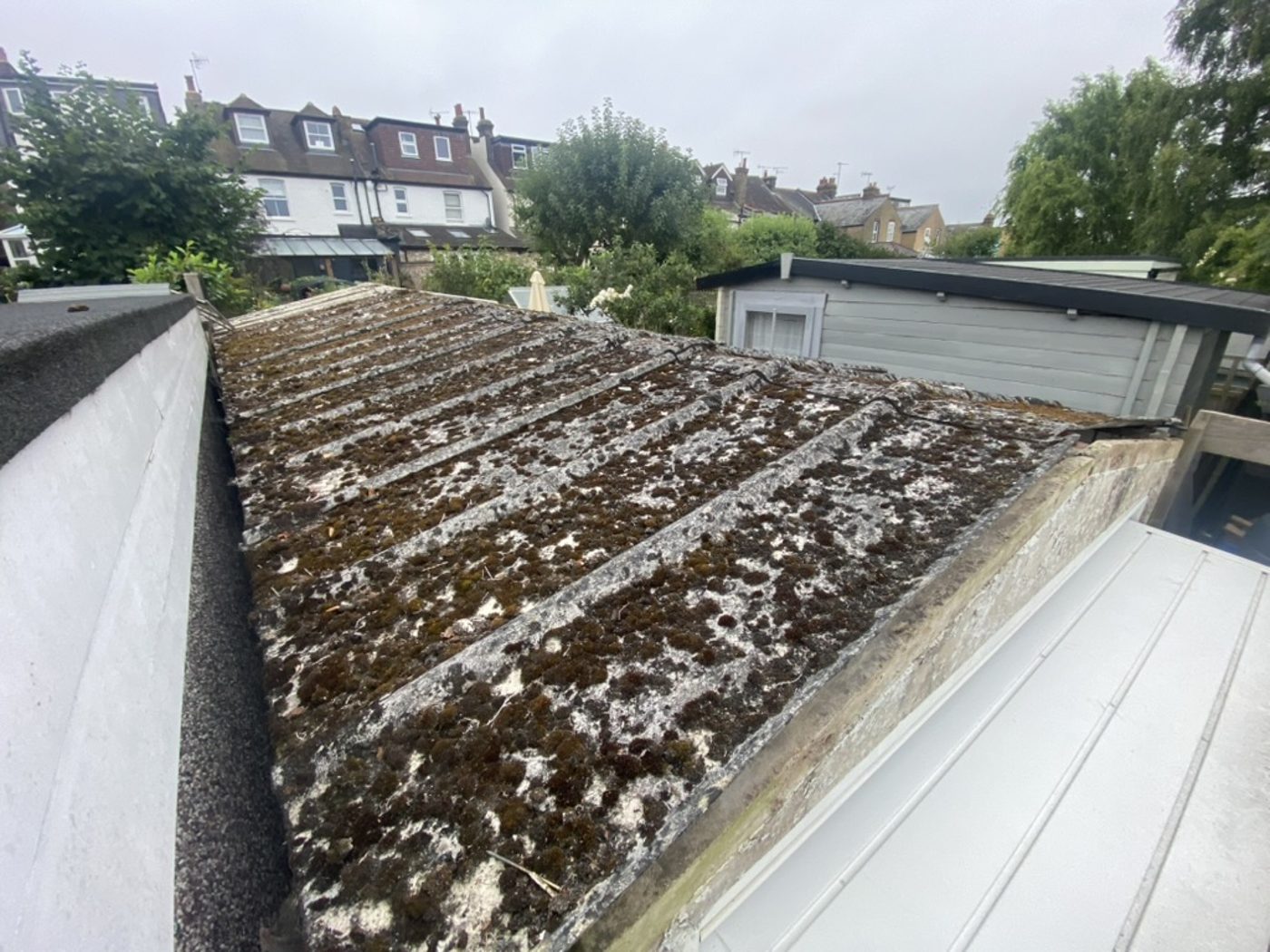 Garage with old asbestos cement roof — before